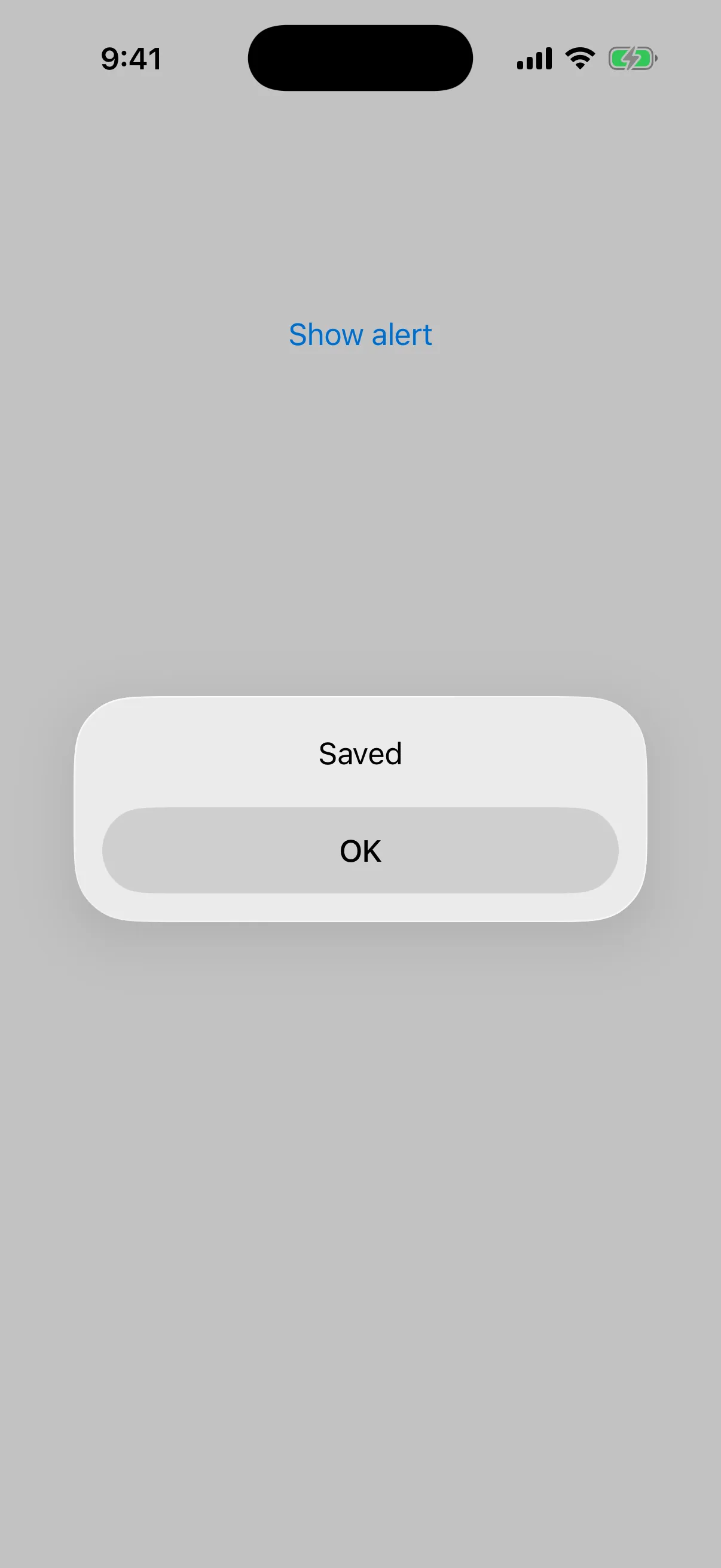 Alert titled Saved with a single OK button, above the Show alert trigger